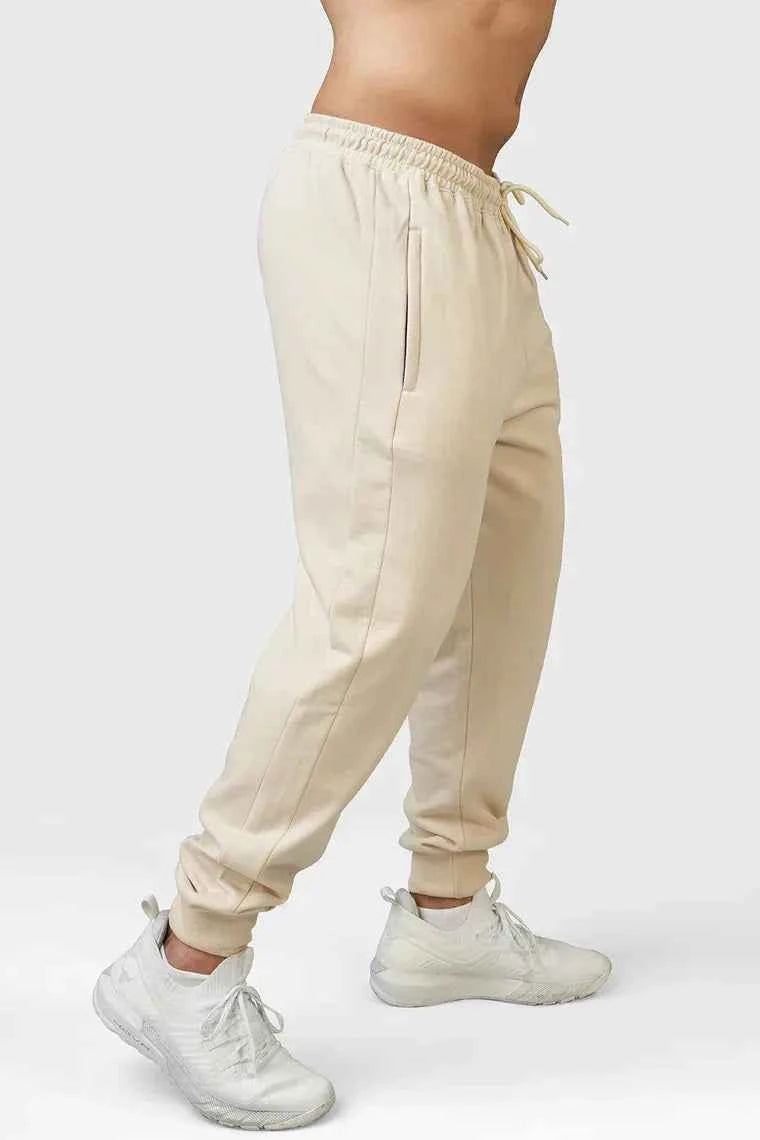 Fuaark Nz Signature Oversized Beige Joggers showing relaxed fit, soft fabric, and elastic waistband on a plain background.