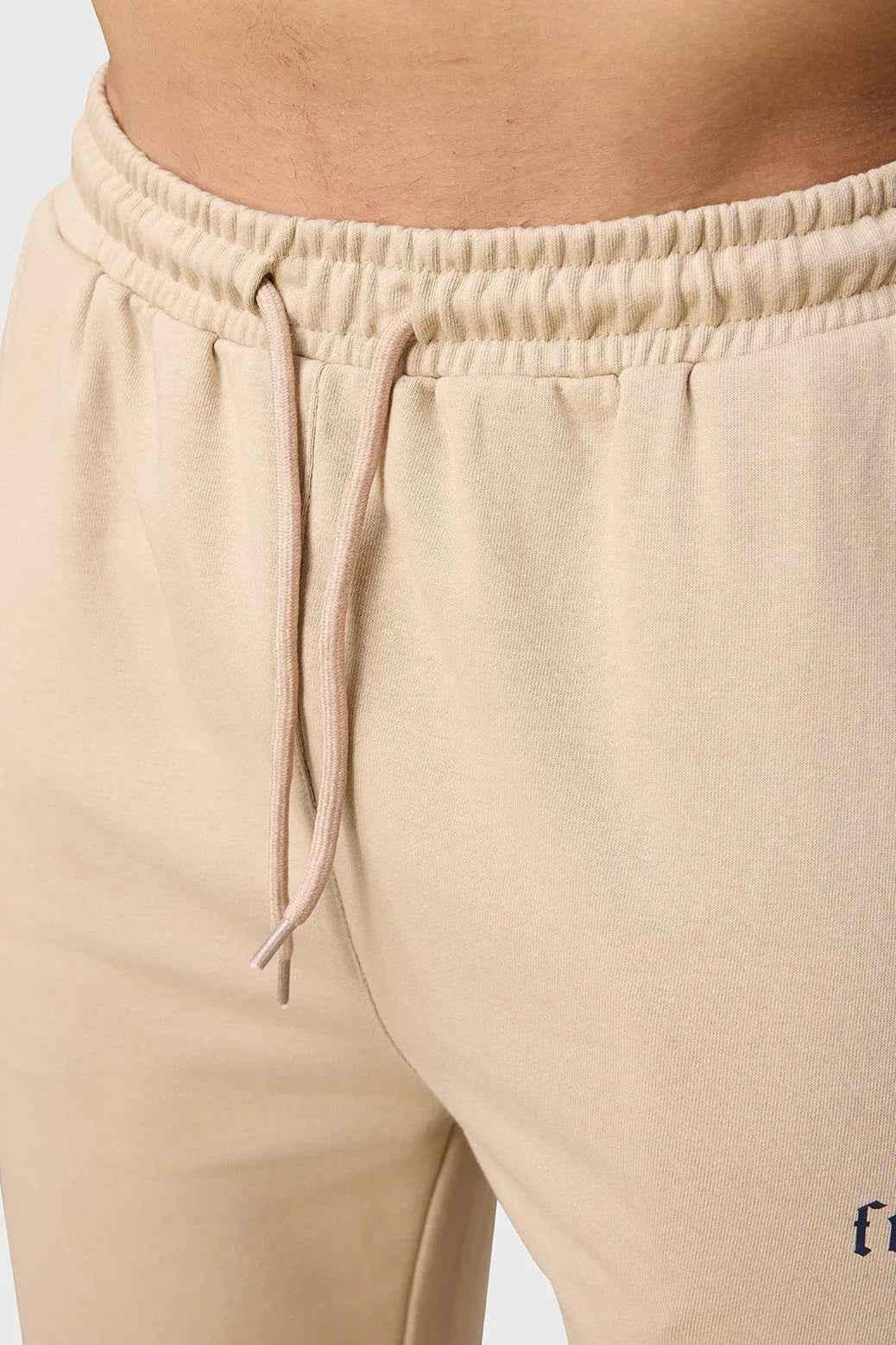 Beige Pinnacle Pocket Pants joggers by Fuaark Nz, showing relaxed fit and pocket details on soft fabric.