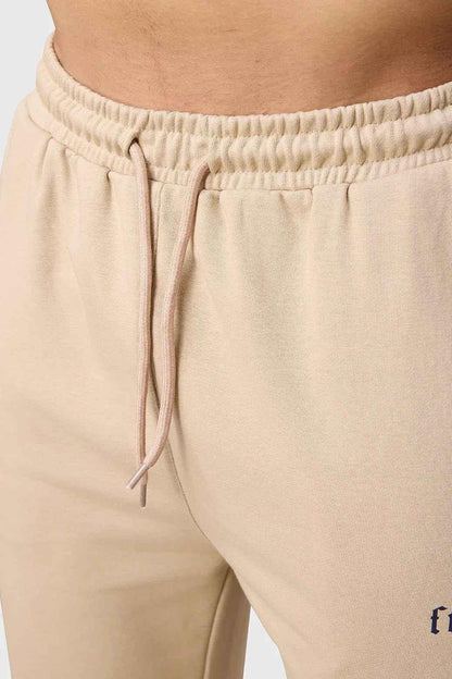 Beige Pinnacle Pocket Pants joggers by Fuaark Nz, showing relaxed fit and pocket details on soft fabric.