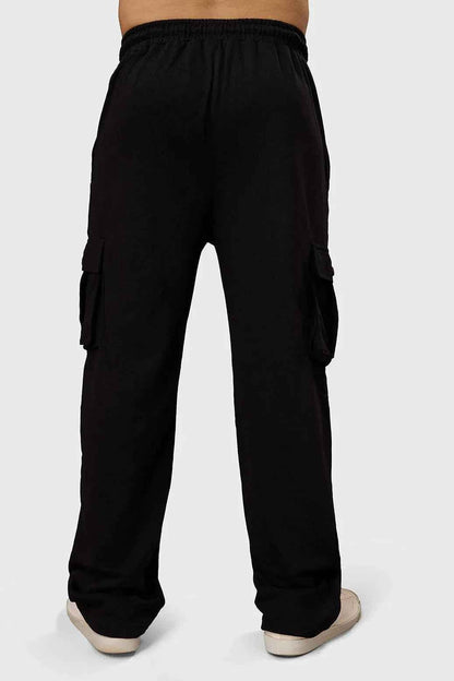 Black Fuaark Nz Pinnacle Pocket Pants joggers with side pockets and a relaxed fit, shown on a model.