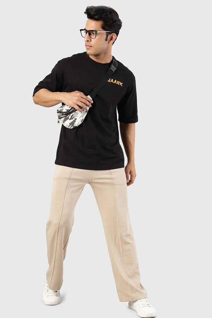 Fuaark Nz Pinnacle Straight Pants beige joggers, slim fit with a comfortable design, shown on a model.