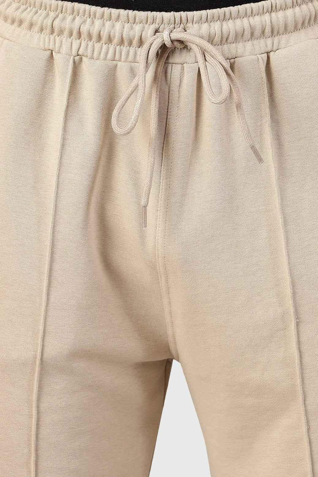 Beige Pinnacle Straight Pants joggers by Fuaark Nz, featuring a relaxed fit and casual style, shown on a model.