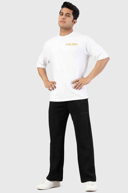 Fuaark Nz Pinnacle black straight-leg pants with oversized fit and 2-way stretch, shown on a model in a casual setting.