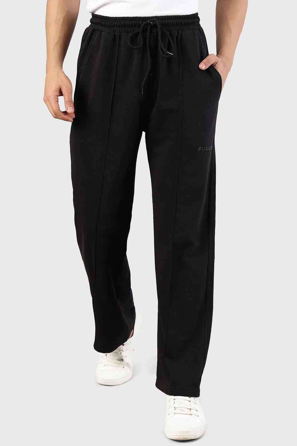 Fuaark Nz Pinnacle black straight-leg pants with oversized fit and 2-way stretch, displayed on a hanger against a white background.