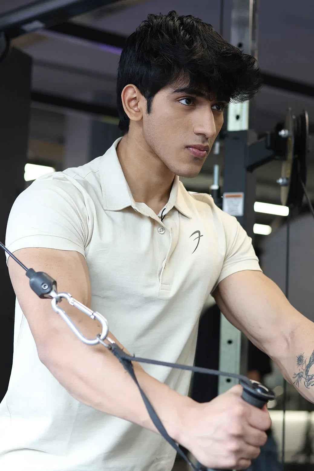 Beige Polo T-shirt by Fuaark Nz featuring a classic collar and short sleeves, displayed on a plain background.