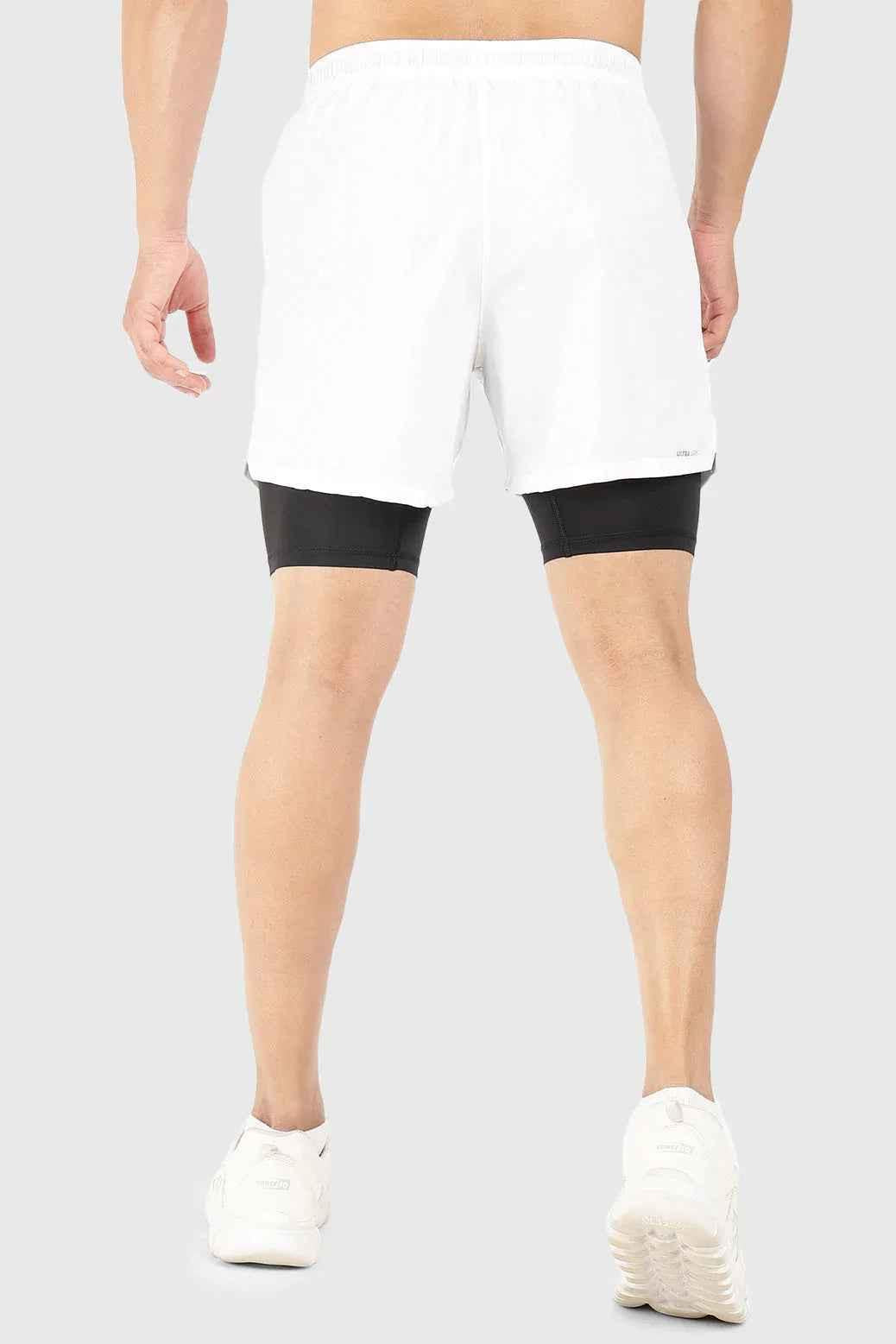 White 2-in-1 5-inch compression shorts by Fuaark Nz, featuring breathable fabric and athletic fit for comfortable active wear.