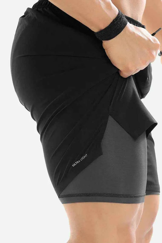 Black 2 in 1 compression shorts by Fuaark Nz, featuring stretchy fabric and snug fit for active wear and support.