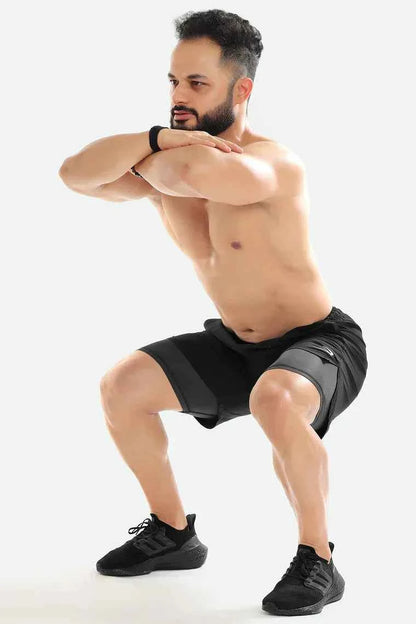 Black 2-in-1 compression shorts by Fuaark Nz, featuring a snug fit and athletic design for active wear.