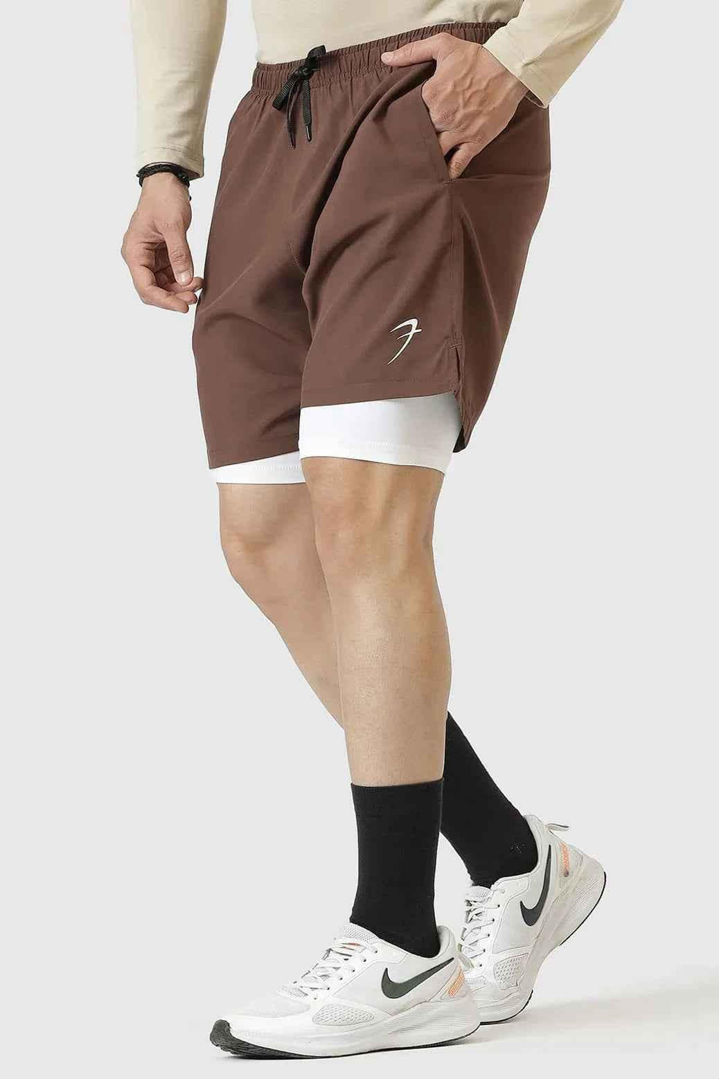 Brown 2-in-1 compression shorts by Fuaark NZ, featuring stretch fabric and athletic fit for active wear.