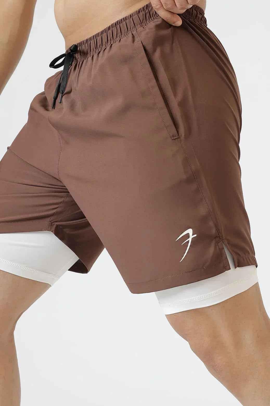 Brown 2-in-1 compression shorts by Fuaark Nz with fitted design and stretch fabric for active wear and support.