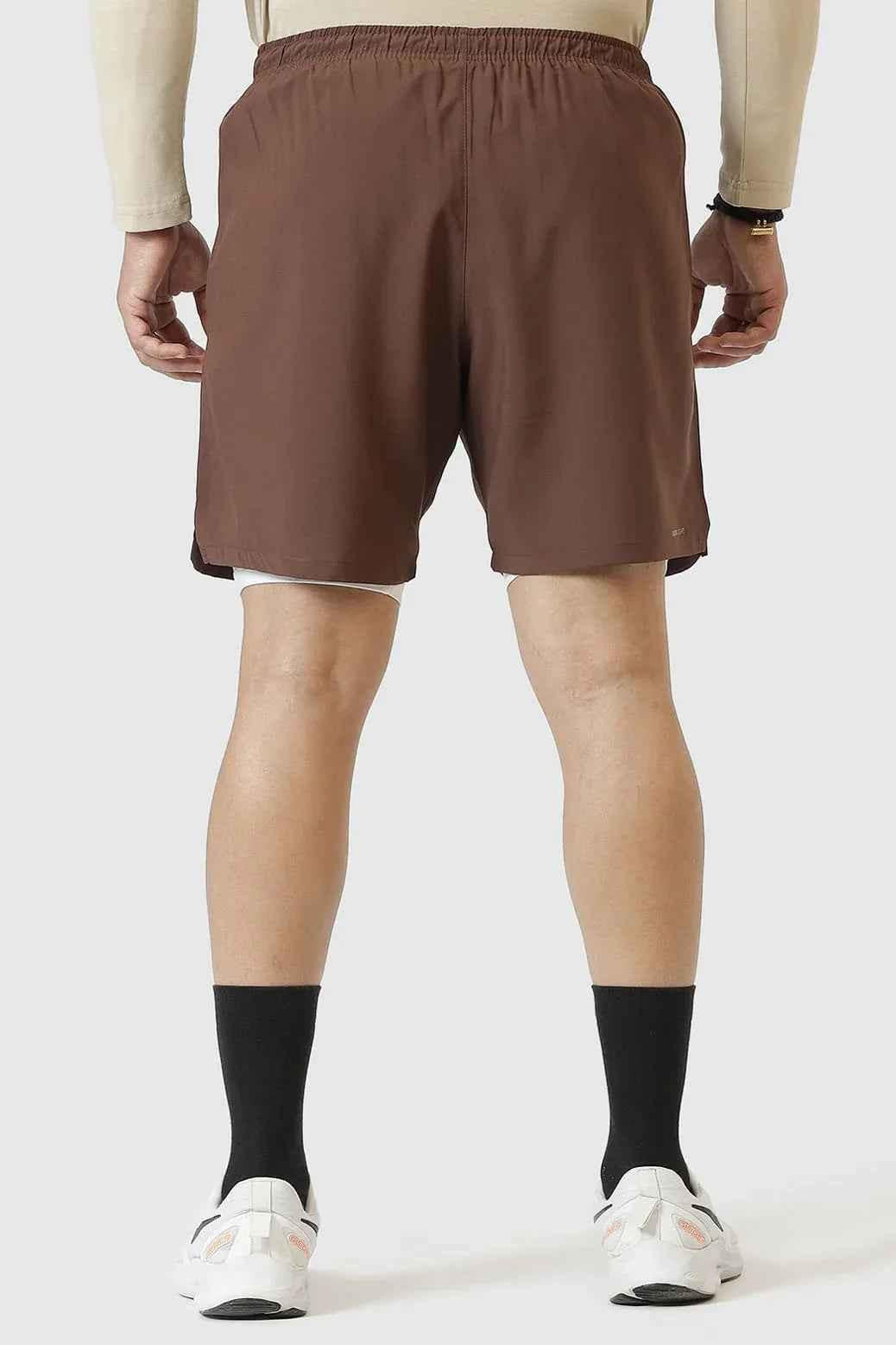 Brown 2-in-1 compression shorts by Fuaark NZ with a snug fit and flexible fabric for active wear and comfort.