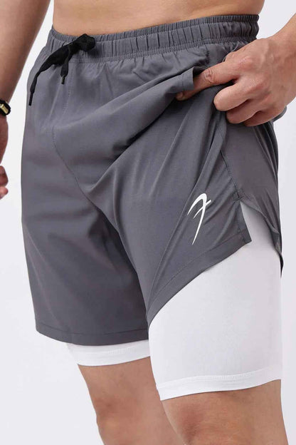 Fuaark Nz 2-in-1 compression shorts in grey with white accents, fitted design for athletic performance and comfort.
