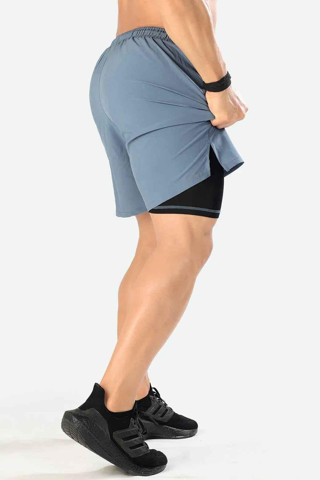 Light grey 2-in-1 compression shorts by Fuaark Nz, featuring stretchy fabric and a comfortable fit for active wear.