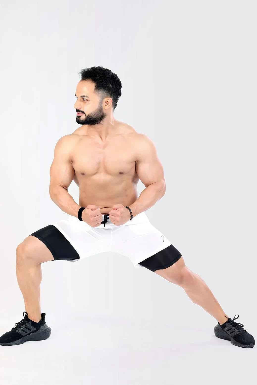 White 2-in-1 compression shorts by Fuaark Nz with stretchy fabric and supportive fit, perfect for athletic activities.