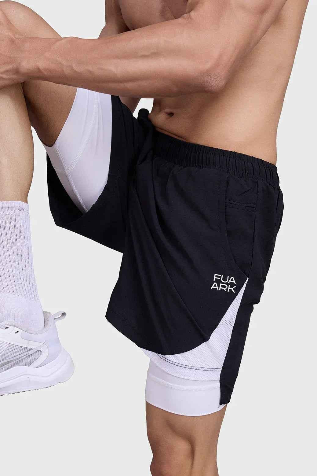 Black and white 2-in-1 mesh shorts by Fuaark Nz, featuring breathable fabric and sporty design for active wear.