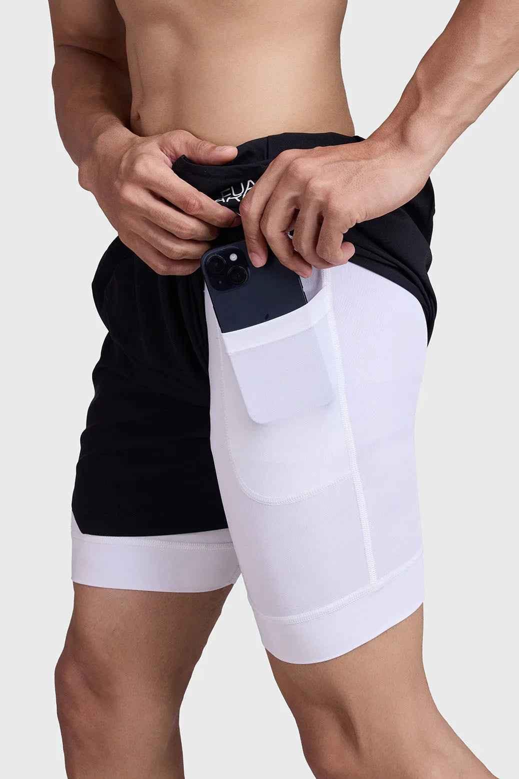 Black and white 2-in-1 mesh shorts by Fuaark Nz, featuring breathable fabric and sporty design for active wear.