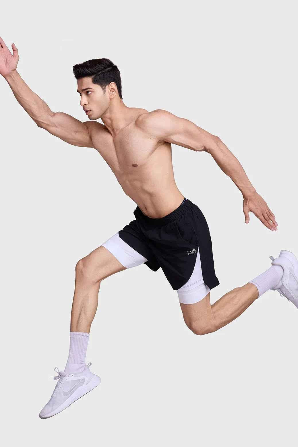 Black and white 2-in-1 mesh shorts by Fuaark Nz, featuring breathable fabric and sporty design for active wear.