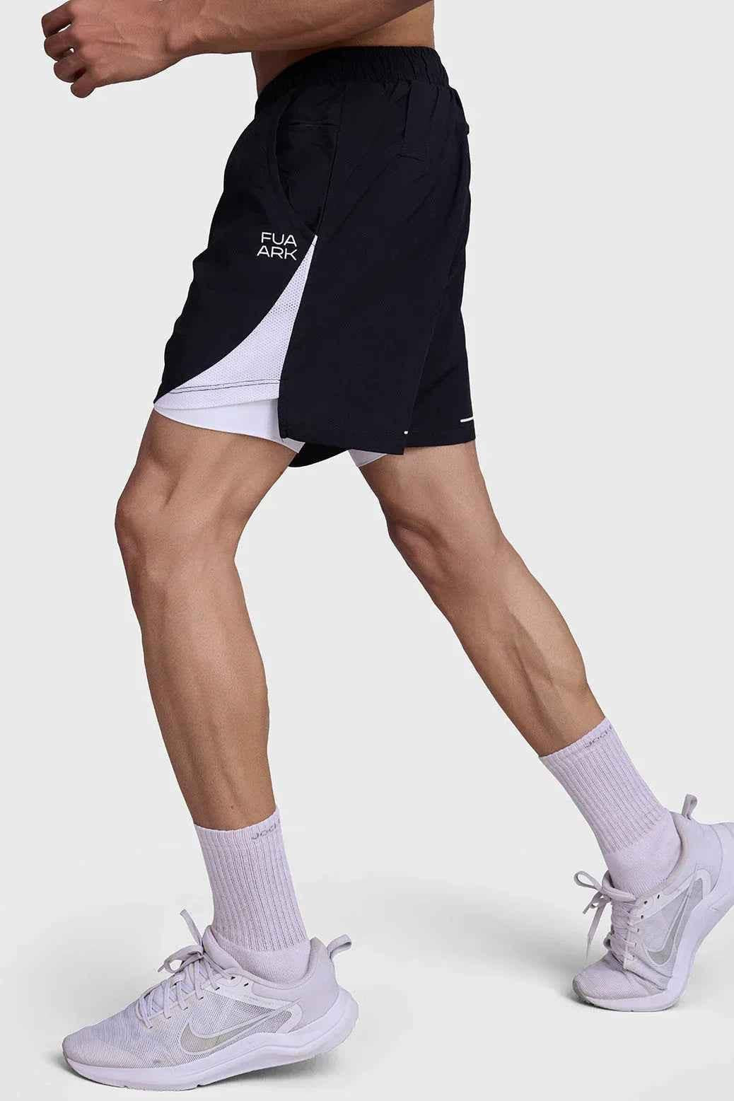 Black and white 2-in-1 mesh shorts by Fuaark Nz, featuring breathable fabric and stylish sporty design.