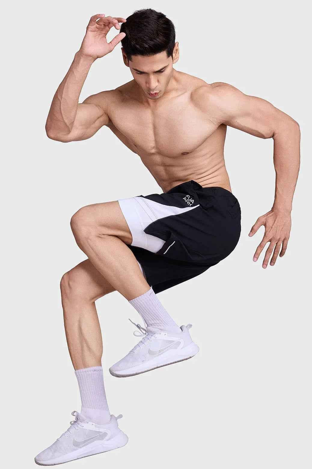 Fuaark Nz 2-in-1 mesh shorts in black and white, sporty design with breathable fabric, ideal for active wear and workouts.
