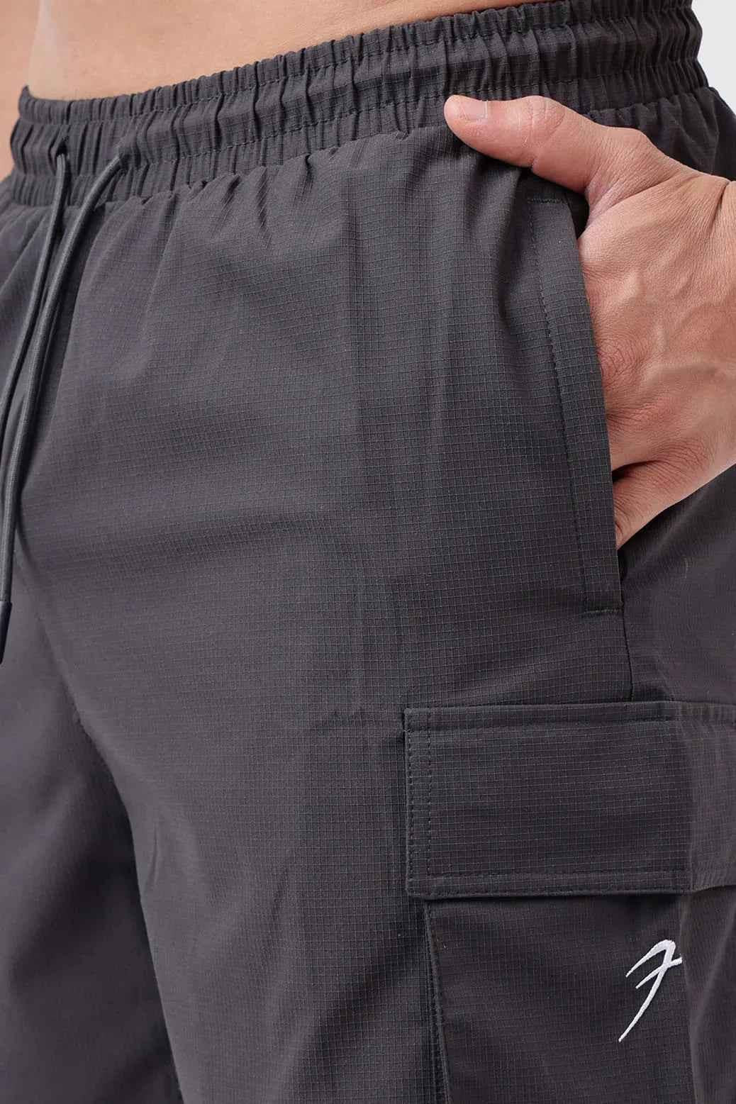 Fuaark Nz Delta cargo shorts in grey displayed on a model, showcasing the relaxed fit and multiple cargo pockets.