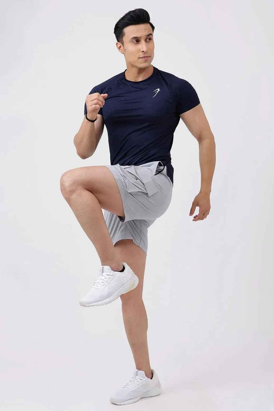 Light grey Delta Cargo Shorts by Fuaark NZ, featuring multiple pockets and a comfortable fit, shown on a model.