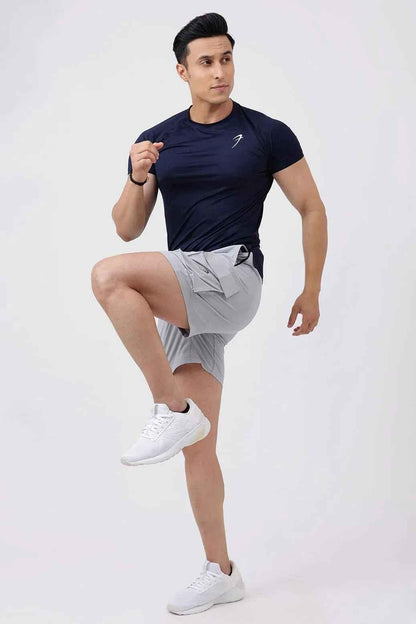 Light grey Delta Cargo Shorts by Fuaark NZ, featuring multiple pockets and a comfortable fit, shown on a model.