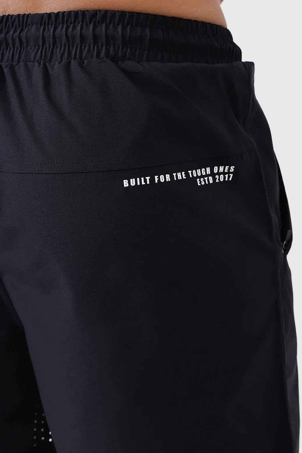 Black Nova Shorts by Fuaark Nz laid flat, showcasing their stylish design and comfortable fit in a casual fashion setting.