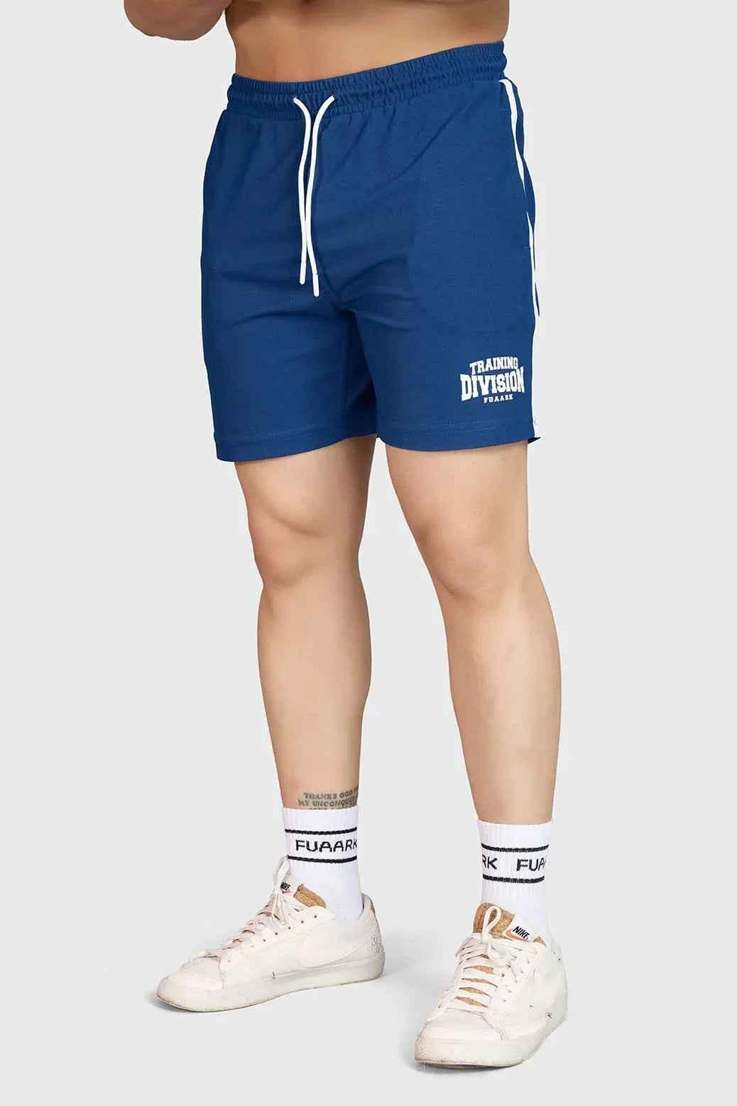 Fuaark Nz Grit Shorts Orion Blue displayed on a model, featuring a casual fit and vibrant blue color for outdoor activities.