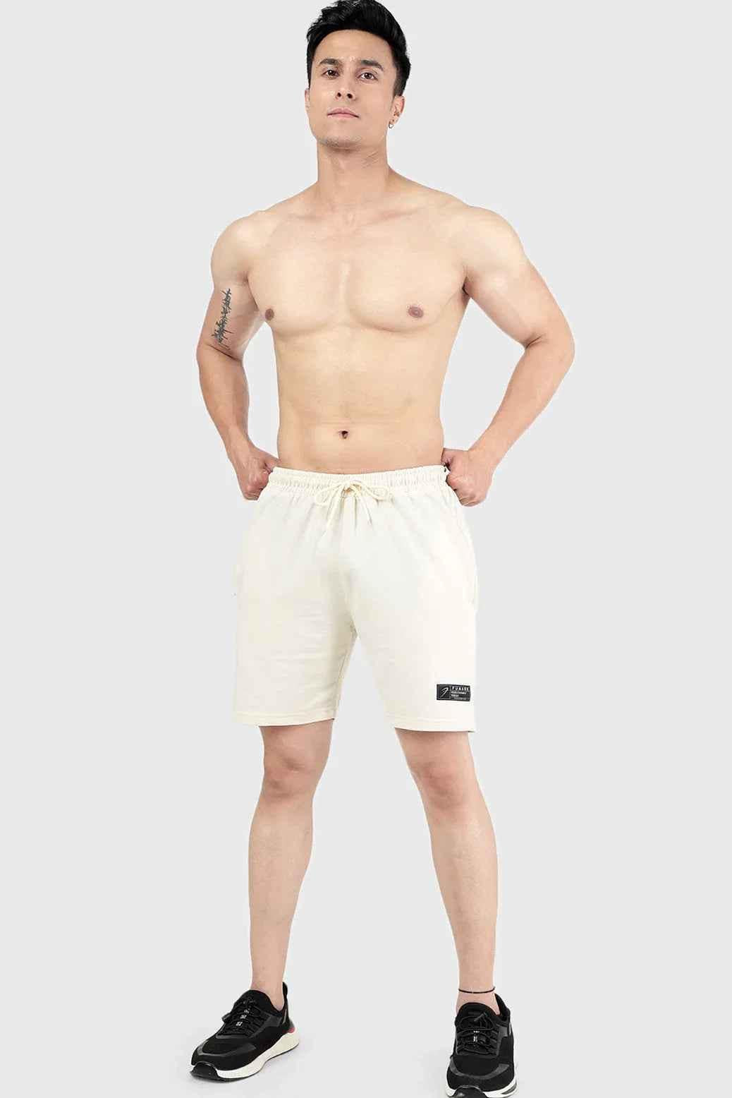 Beige Fuaark Nz Venture Shorts shown on a model, featuring a relaxed fit and casual style perfect for summer wear.