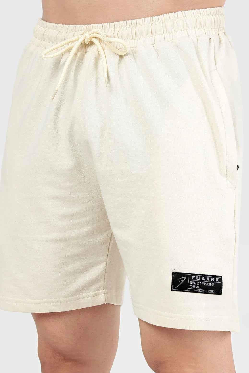 Beige Fuaark NZ Venture Shorts laid flat, showing their casual fit and cotton fabric, ideal for summer wear.