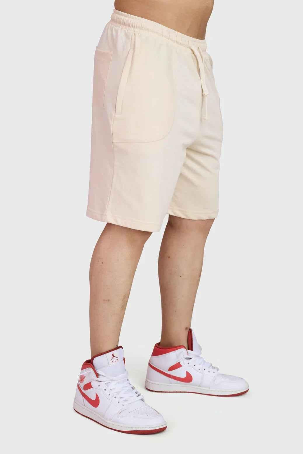 Beige oversized shorts by Fuaark Nz, designed for ultimate comfort, featuring a relaxed fit and casual style.