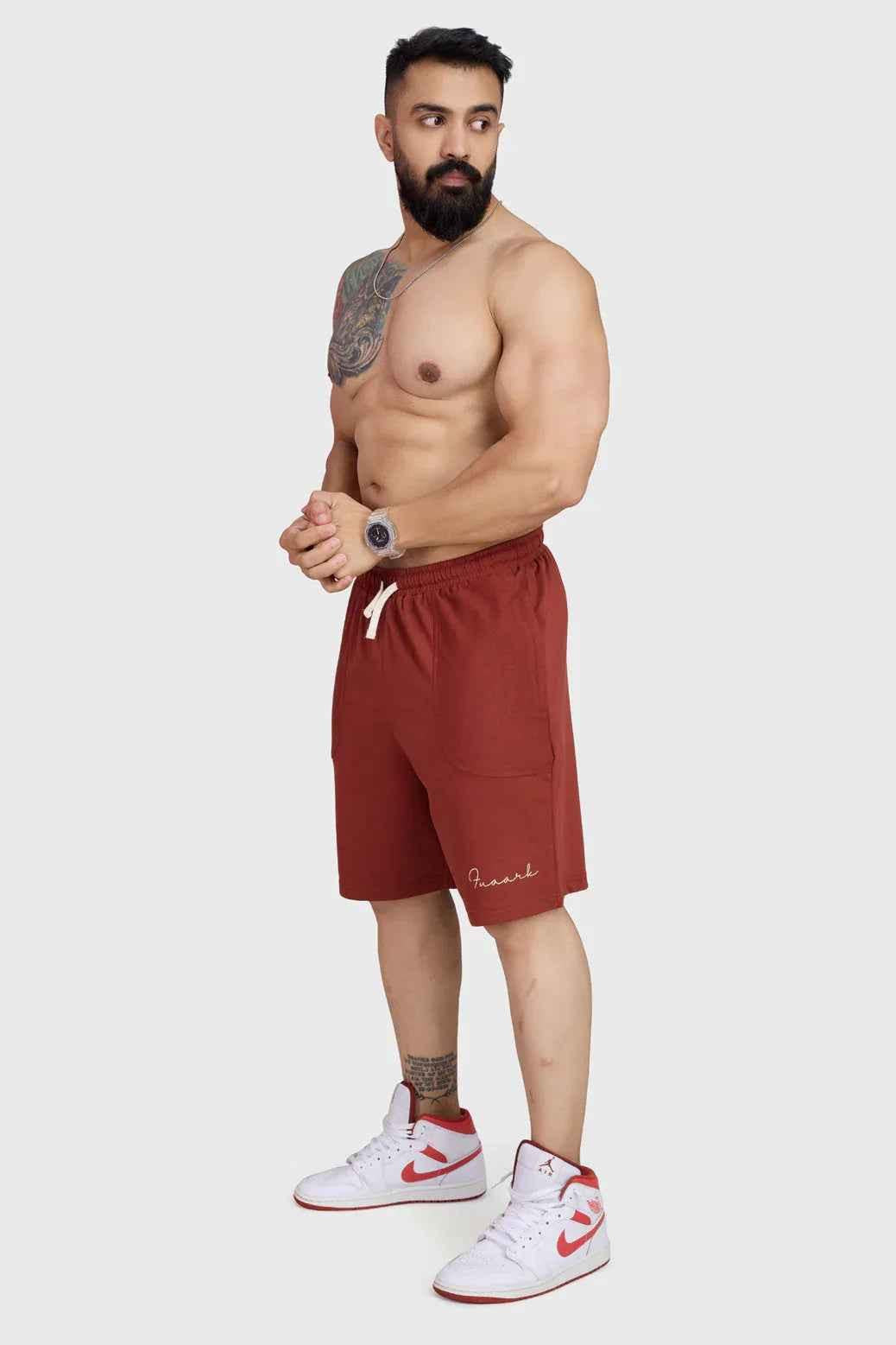 Rust-colored oversized shorts by Fuaark Nz, designed for comfort, with a relaxed fit and casual style.