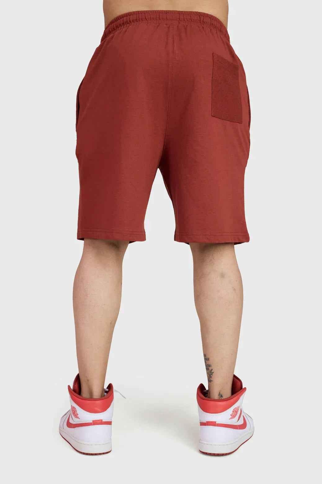 Fuaark Nz weekend rust oversized shorts hanging on a hanger showcasing relaxed fit and comfortable casual style.