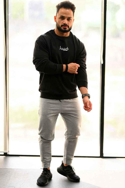 Black oversized sweatshirt from Fuaark Nz, cozy and stylish, perfect for effortless casual wear.