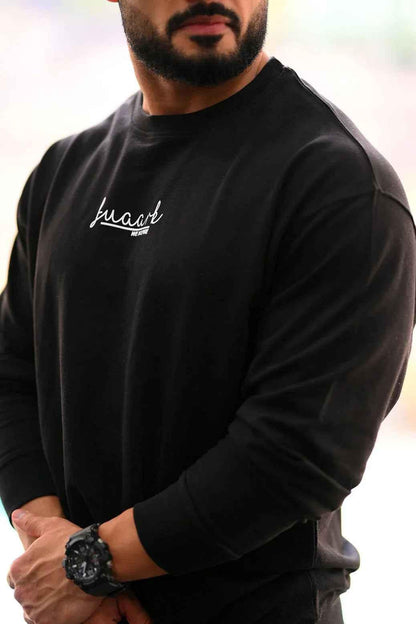 Black oversized sweatshirt from Fuaark Nz, cozy and stylish, perfect for effortless casual wear and comfort.