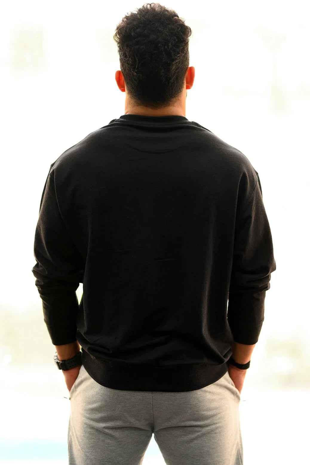 Black oversized sweatshirt from Fuaark Nz, showcasing a cozy, relaxed fit perfect for effortless style and comfort.