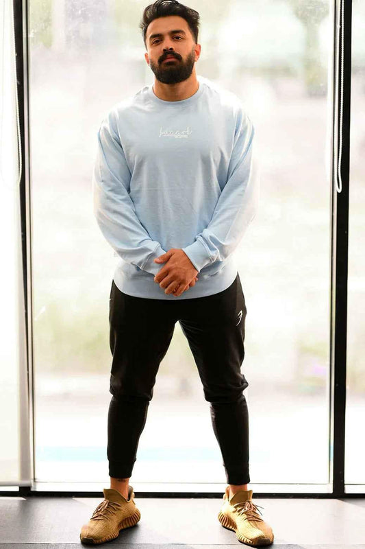 Sky blue oversized sweatshirt by Fuaark Nz featuring a relaxed fit and comfortable style, shown on a plain background.