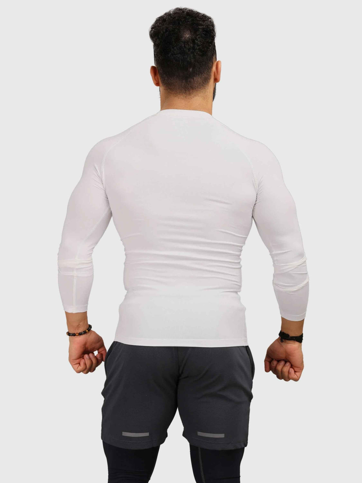 White compression full sleeves T-shirt by Fuaark Nz, designed for enhanced athletic performance and comfort.