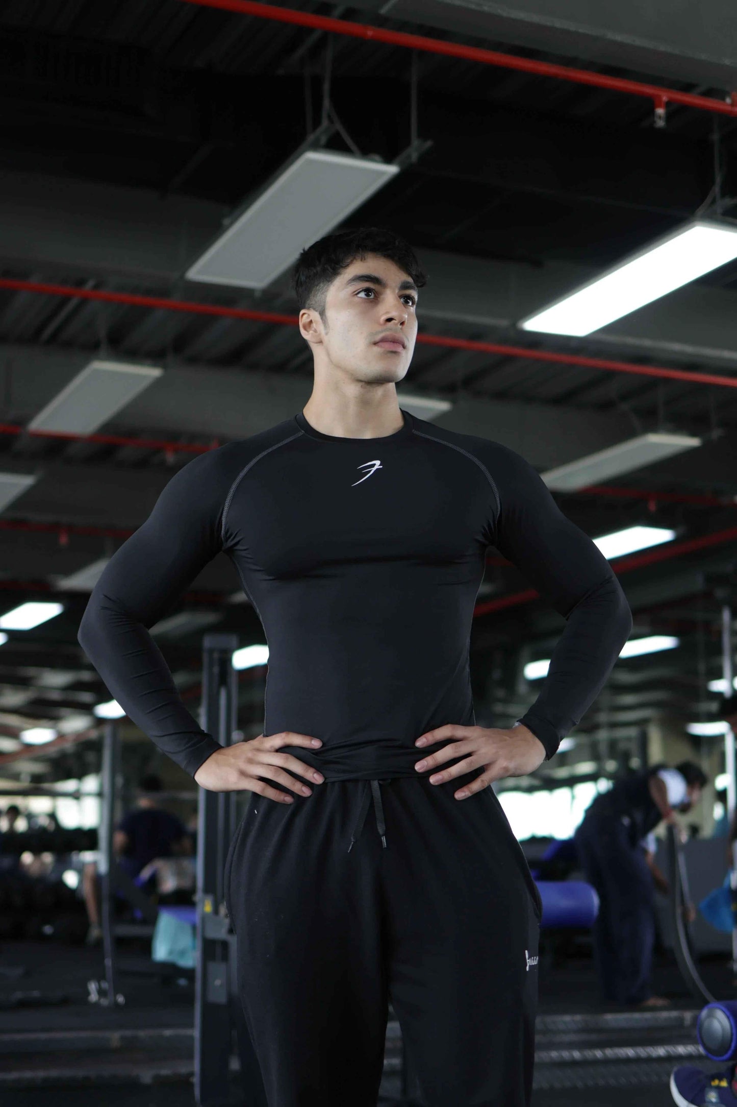 Black compression fullsleeves T-shirt by Fuaark Nz, showcasing the fitted design and lightweight fabric.