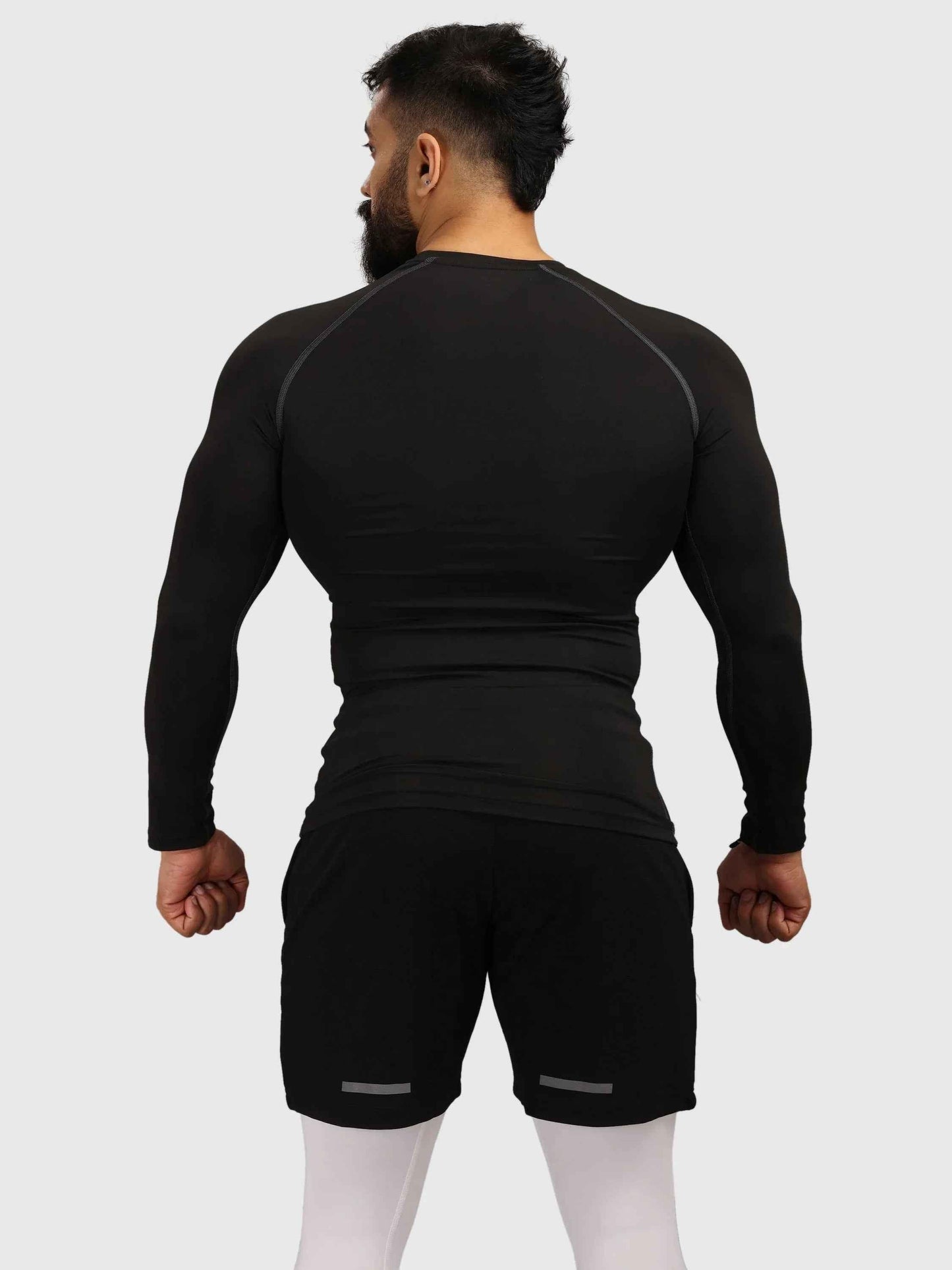 Black compression full-sleeve T-shirt by Fuaark Nz, fitted athletic shirt with long sleeves and breathable fabric.