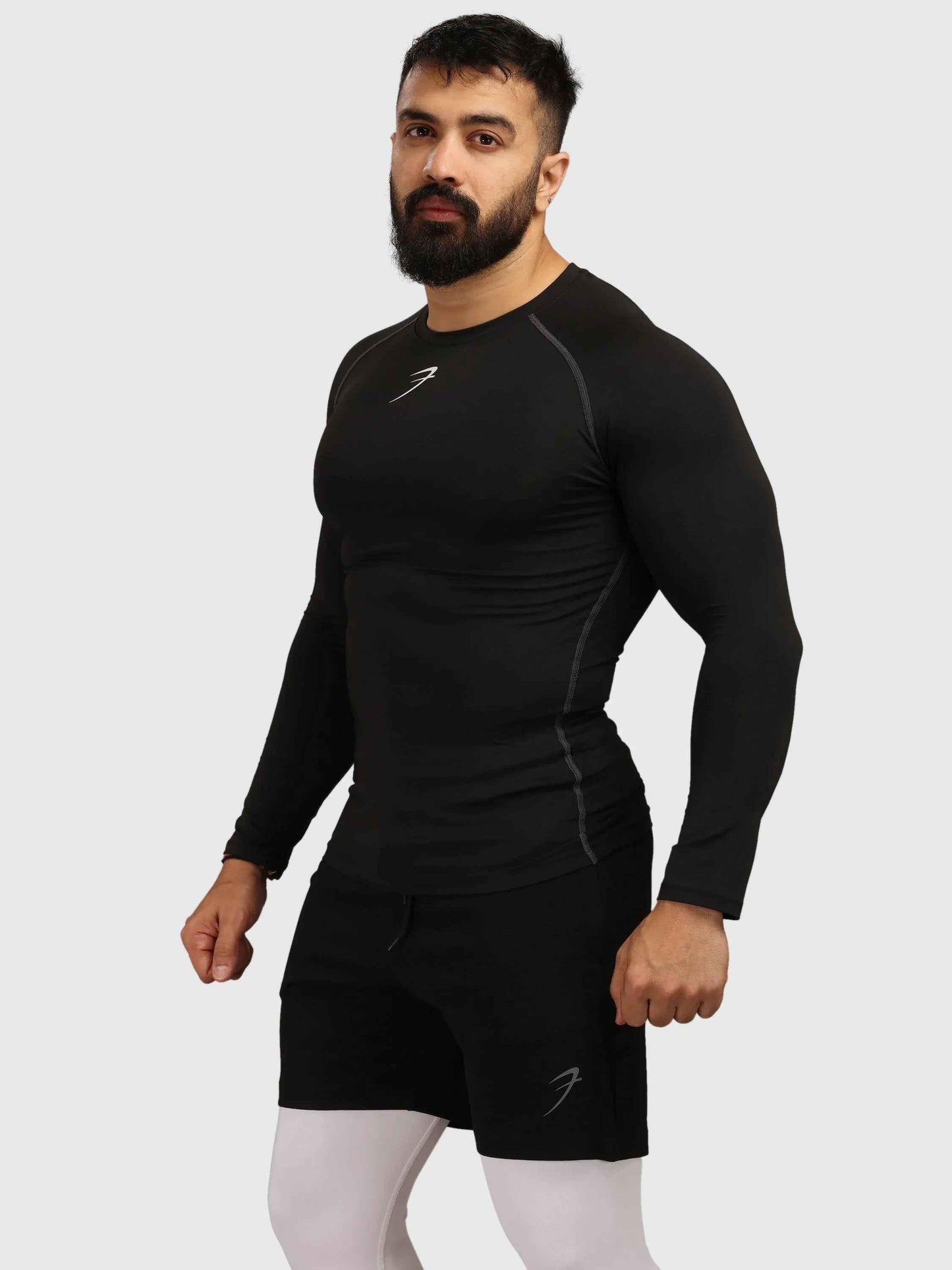 Black compression full-sleeves T-shirt by Fuaark Nz, designed for performance and athletic wear, shown on a plain background.