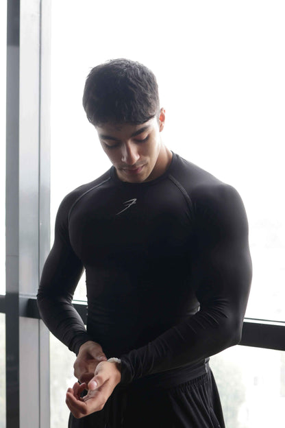 Black compression full-sleeve T-shirt by Fuaark Nz, showcasing a fitted design and breathable fabric for athletic wear.