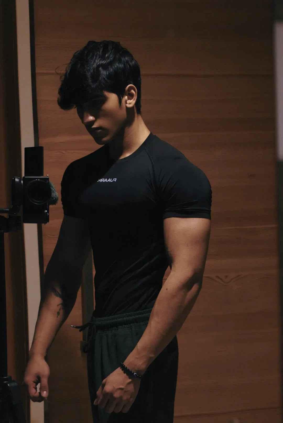 Black compression T-shirt by Fuaark Nz designed for ultimate performance and comfort, shown on a model.