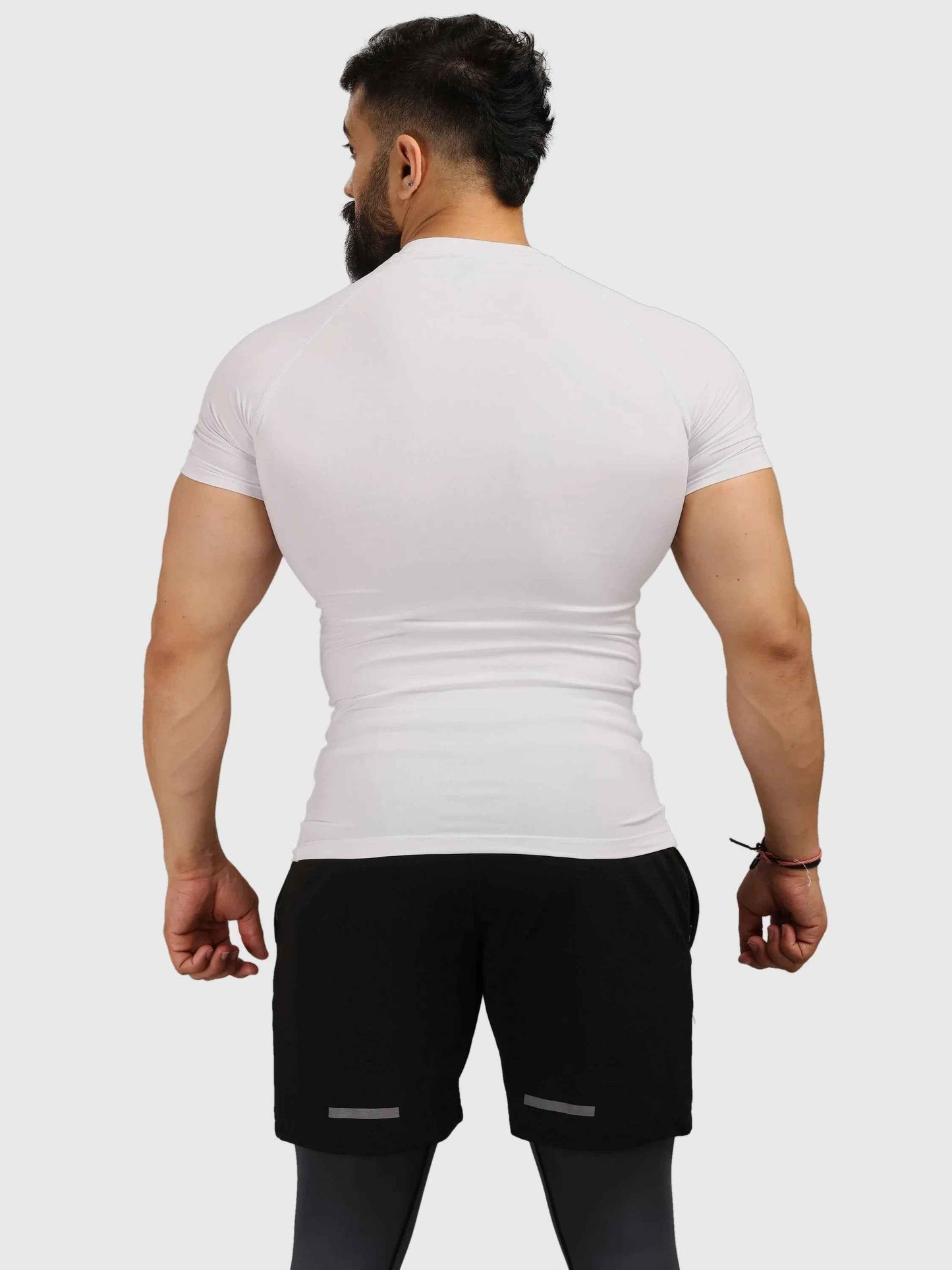 White Fuaark Nz performance compression T-shirt, designed for athletic comfort and support during workouts.