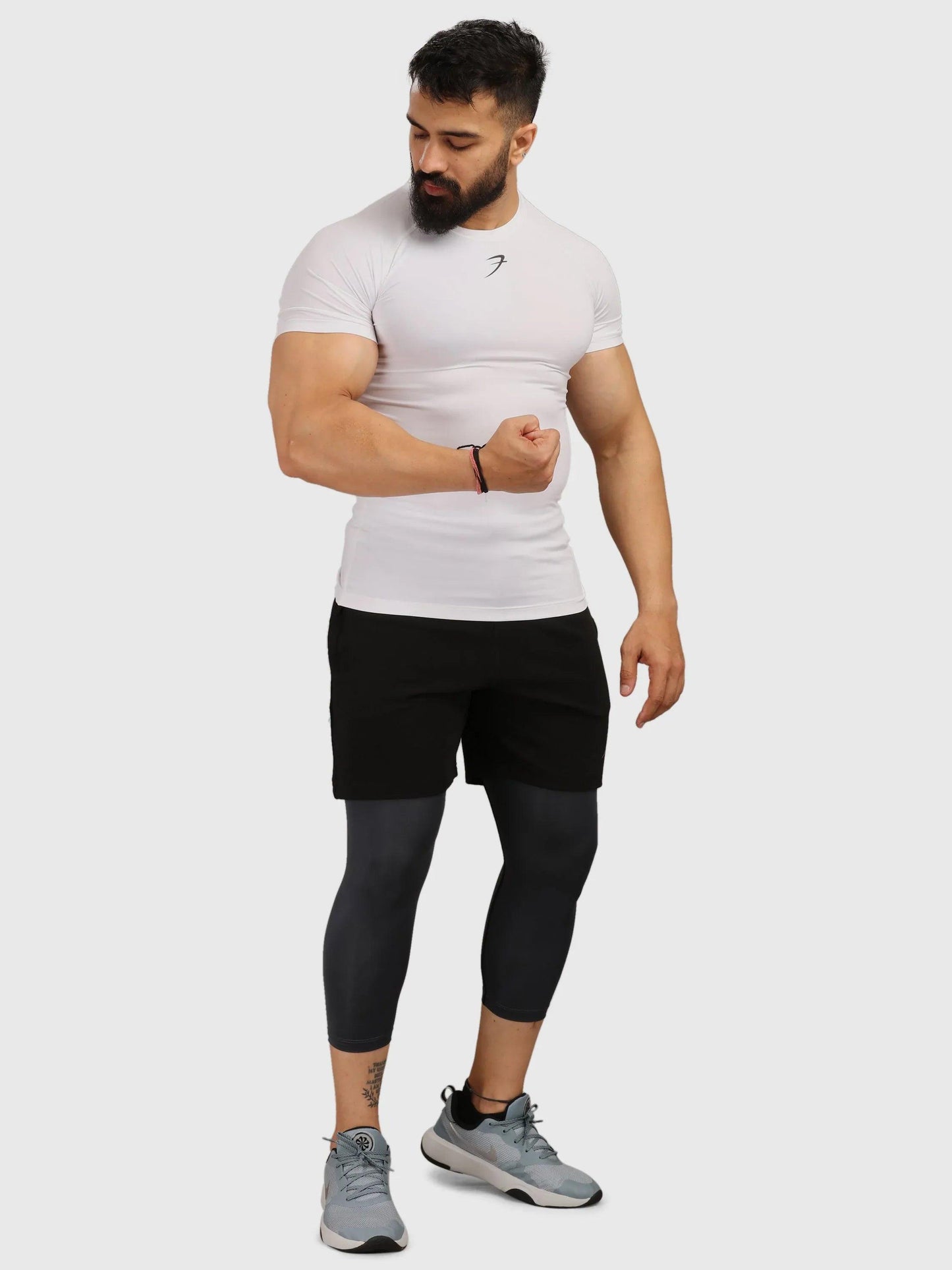 White Fuaark Nz performance compression T-shirt for athletes, designed to enhance movement and support during workouts.