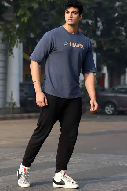 Fuaark Nz Greatest Oversized Grey T-Shirt laid flat, showing its relaxed fit and soft fabric, casual streetwear style.