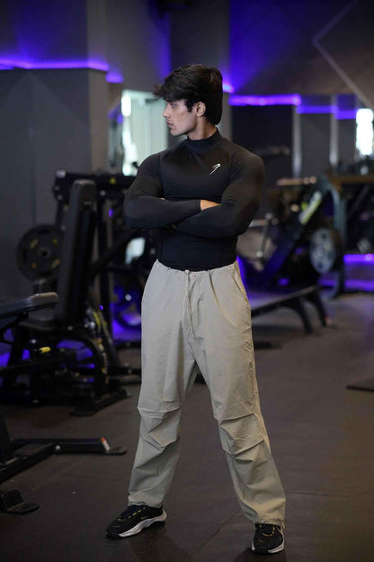 Black high neck compression T-shirt by Fuaark Nz with full sleeves, designed for performance and athletic wear.