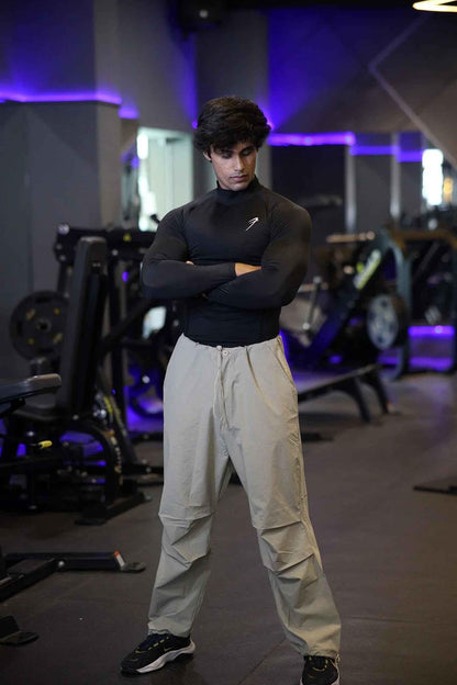 Black high neck compression T-shirt by Fuaark Nz with full sleeves, designed for performance and athletic wear.