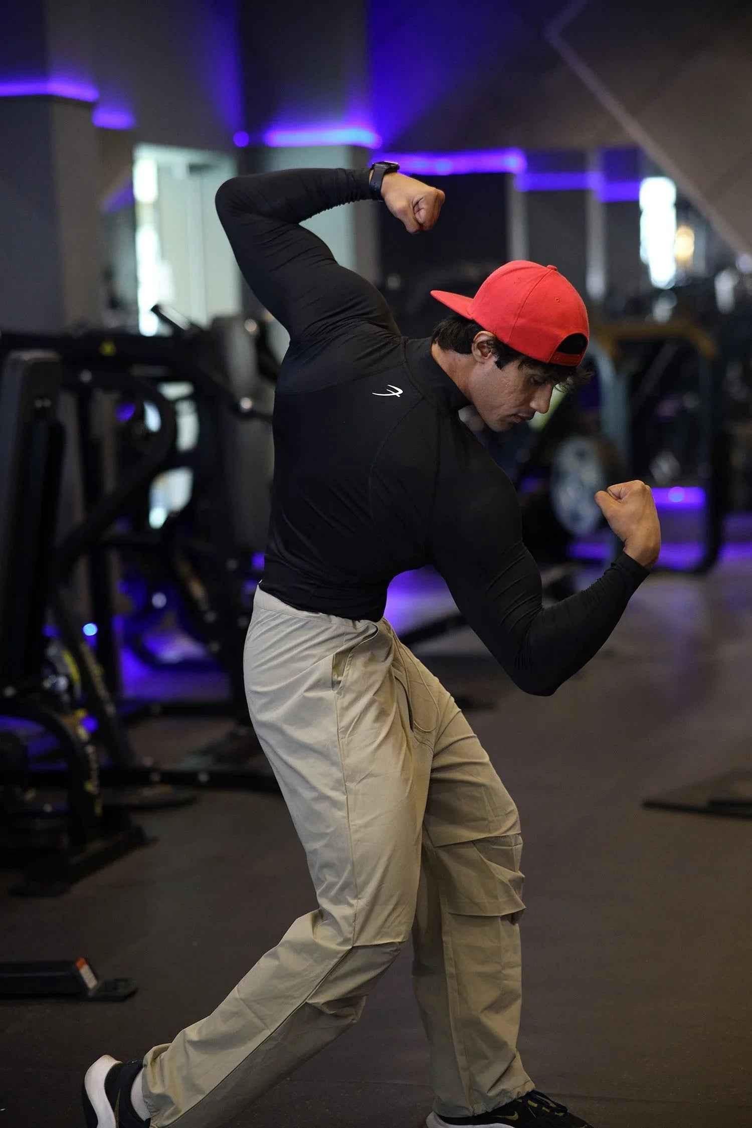 Black high neck compression T-shirt by Fuaark Nz with full sleeves, designed for performance and athletic wear.