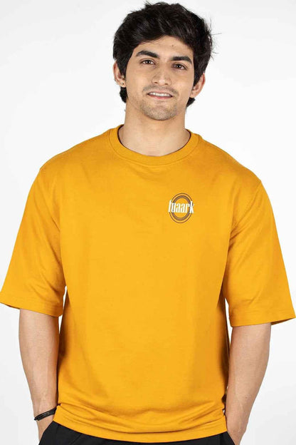Fuaark Nz Zodiac oversized mustard T-shirt with bold graphic design, relaxed fit, and soft cotton fabric.